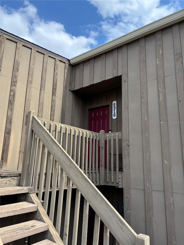 view of exterior entry with board and batten siding