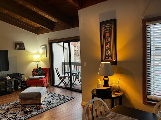 living room featuring lofted ceiling with beams, wood ceiling, and wood finished floors