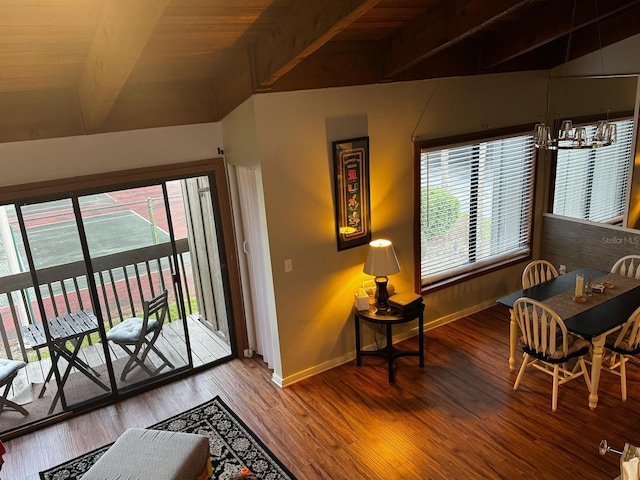 interior space featuring baseboards, a notable chandelier, lofted ceiling, and wood finished floors