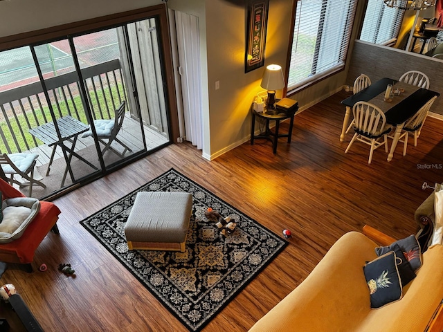 living area with baseboards and wood finished floors