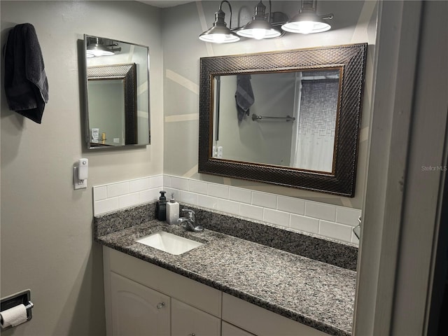 bathroom featuring vanity and tasteful backsplash