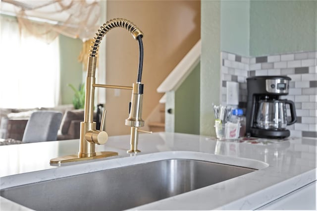 interior details featuring stone counters and a sink