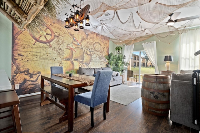 dining space featuring wood finished floors, visible vents, a ceiling fan, baseboards, and wallpapered walls