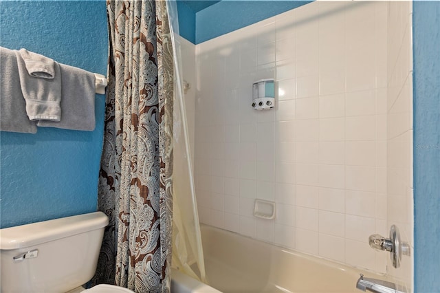 full bath with shower / bath combination with curtain, a textured wall, and toilet