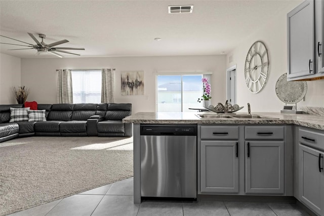 kitchen with a peninsula, visible vents, gray cabinets, and stainless steel dishwasher