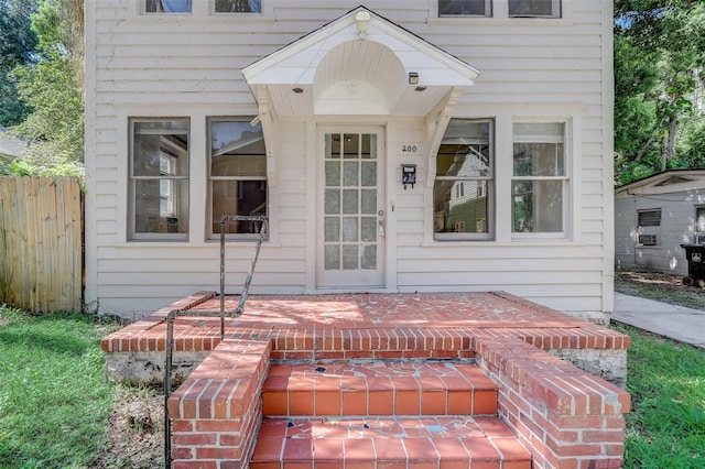 view of exterior entry with fence