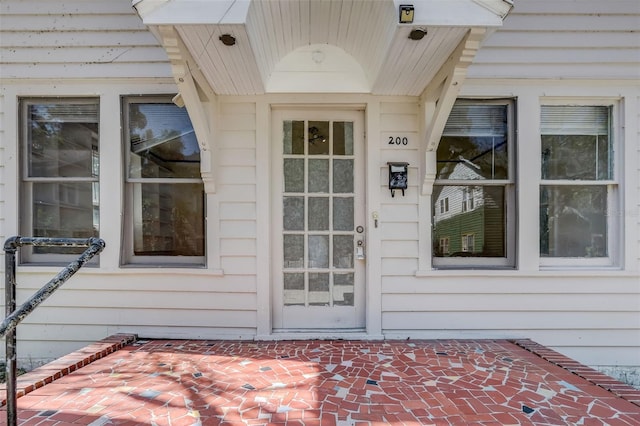 view of exterior entry featuring a patio area