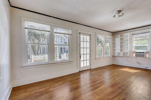 unfurnished sunroom with cooling unit