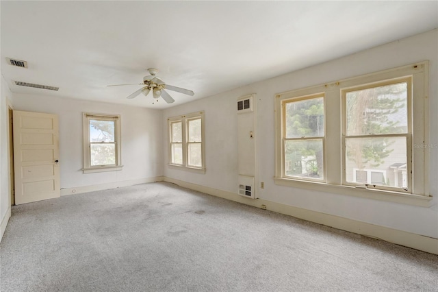 spare room featuring light carpet, baseboards, and visible vents