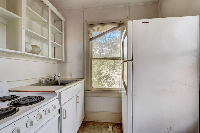 kitchen featuring open shelves, light countertops, white cabinets, a sink, and white appliances