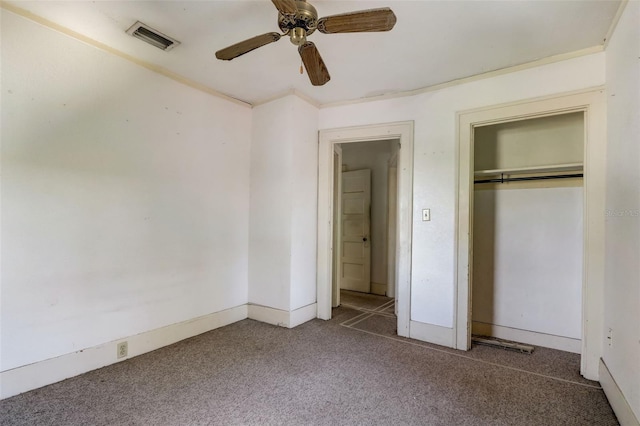 unfurnished bedroom featuring carpet, visible vents, ceiling fan, and a closet