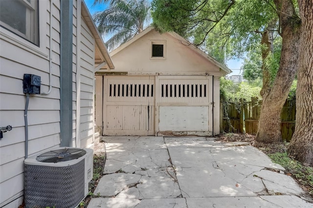 detached garage with cooling unit and fence