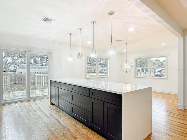 kitchen featuring light countertops, light wood-type flooring, and visible vents