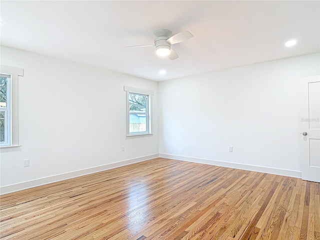 spare room with ceiling fan, recessed lighting, light wood-style flooring, and baseboards