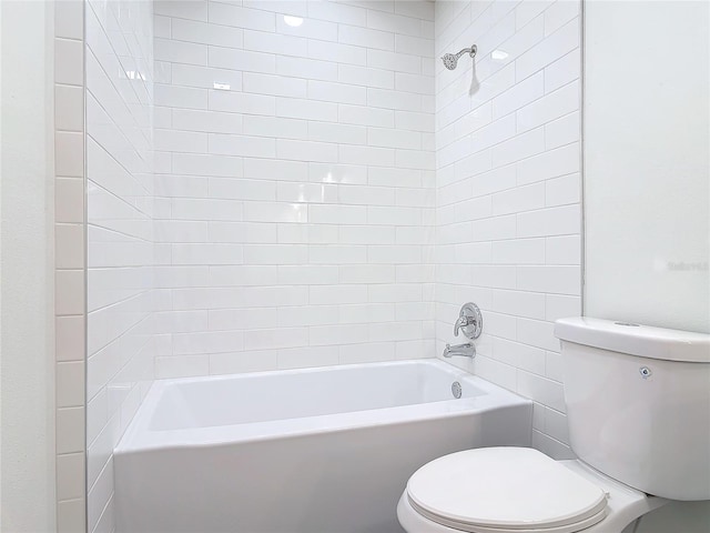 bathroom featuring shower / tub combination and toilet