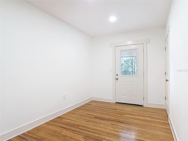 entryway with baseboards and light wood-style floors