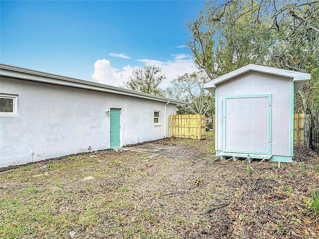 view of shed with fence