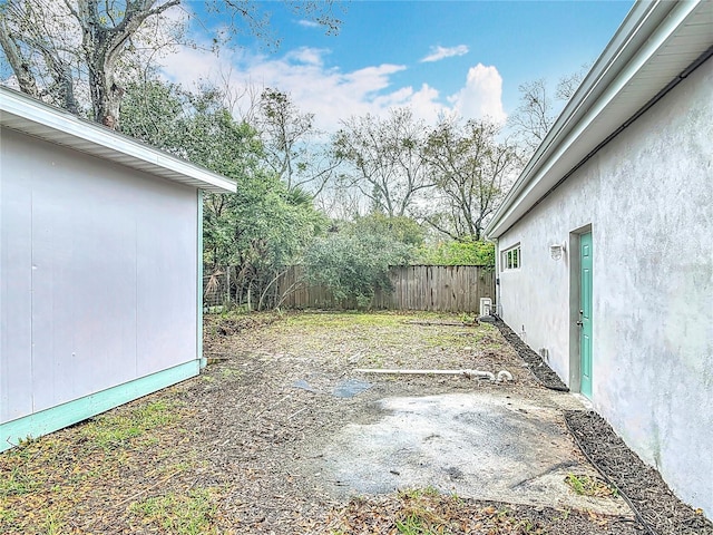 view of yard with fence and an outbuilding