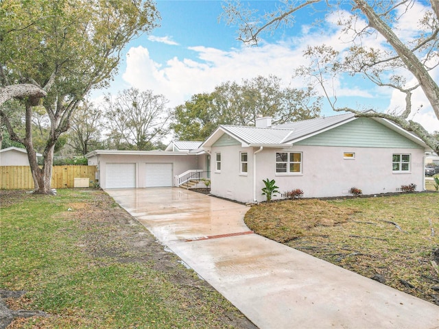 ranch-style house with concrete driveway, an attached garage, a standing seam roof, metal roof, and fence