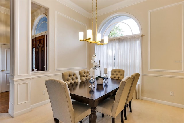 dining area featuring baseboards, an inviting chandelier, and crown molding