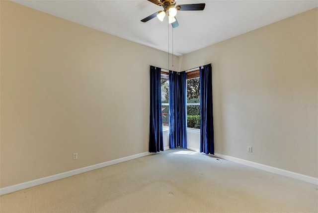 empty room featuring ceiling fan, carpet floors, and baseboards