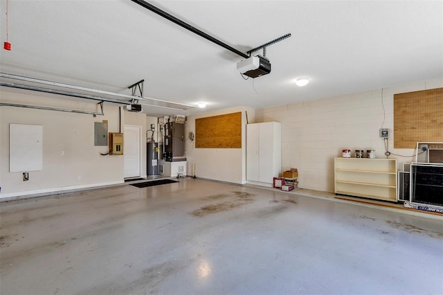 garage featuring a garage door opener, concrete block wall, electric water heater, and electric panel