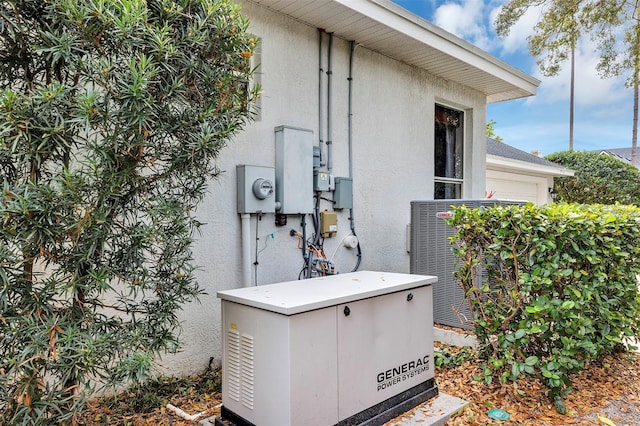 details with central AC, a power unit, and stucco siding