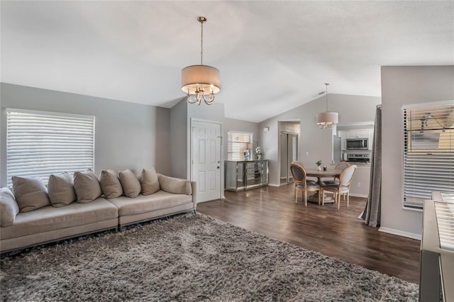 living room with an inviting chandelier, baseboards, vaulted ceiling, and dark wood-style flooring