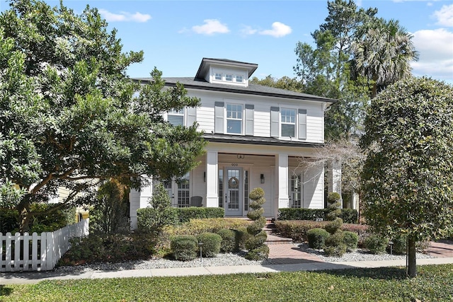 american foursquare style home featuring fence