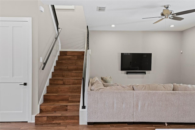 unfurnished living room with recessed lighting, visible vents, a ceiling fan, wood finished floors, and stairs