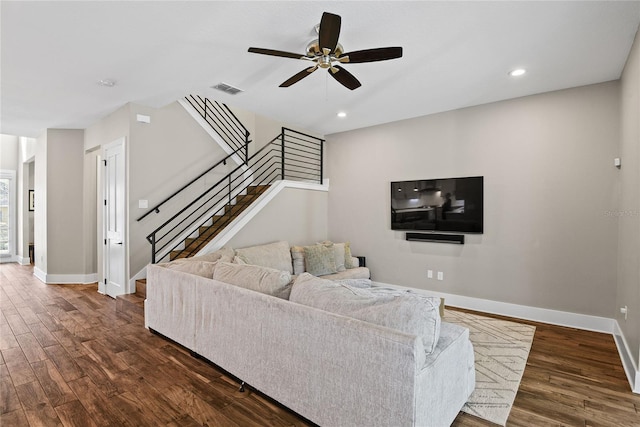 living area featuring dark wood-style floors, visible vents, and baseboards