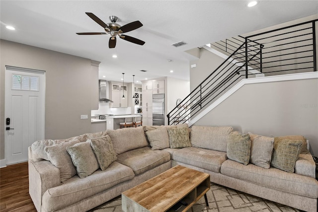 living area with visible vents, a ceiling fan, wood finished floors, stairs, and recessed lighting