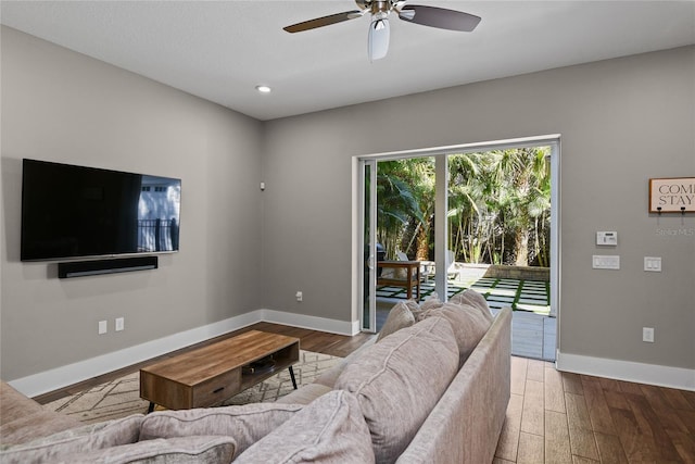 living area with recessed lighting, wood finished floors, a ceiling fan, and baseboards