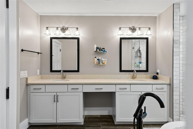 full bath featuring double vanity, a sink, and wood finish floors