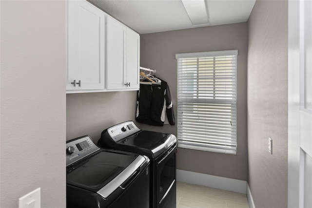 laundry room with cabinet space, independent washer and dryer, baseboards, and light tile patterned flooring