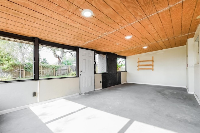 unfurnished sunroom with wood ceiling