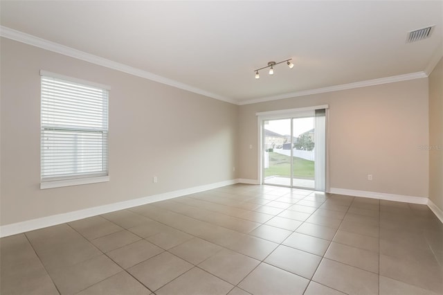 unfurnished room with light tile patterned floors, baseboards, visible vents, ornamental molding, and rail lighting