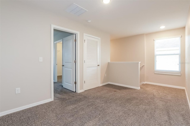 carpeted spare room featuring recessed lighting and baseboards