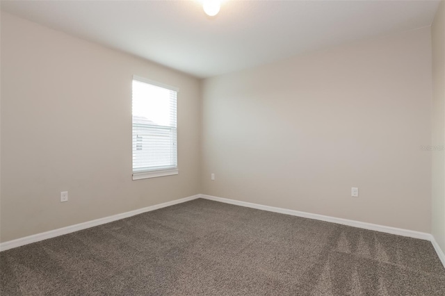 empty room with carpet floors and baseboards