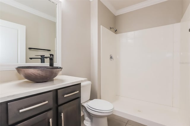 bathroom with crown molding, toilet, a shower stall, vanity, and tile patterned floors