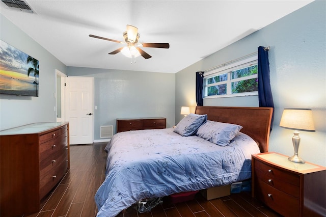 bedroom featuring a ceiling fan, visible vents, and wood finish floors