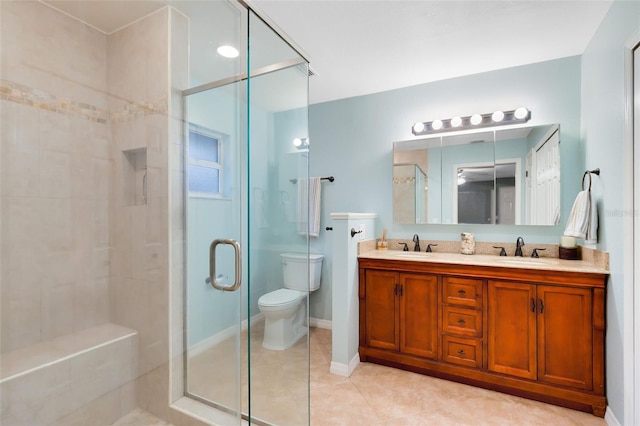 bathroom with a shower stall, tile patterned floors, and a sink