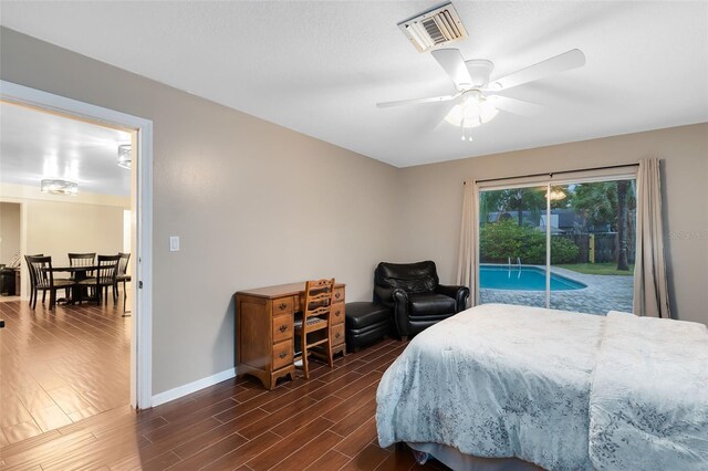 bedroom featuring visible vents, ceiling fan, baseboards, dark wood-style floors, and access to outside