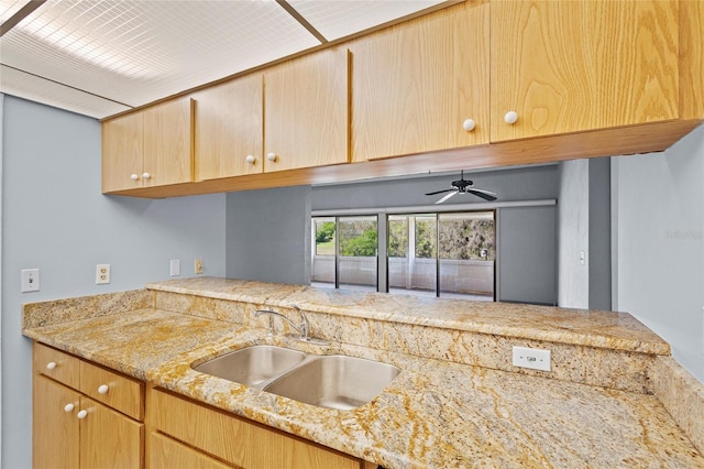 2297 Burnway Rd Unit 2297, Haines City, FL 33844 - kitchen featuring a ceiling fan, light brown cabinets, a sink, and light stone countertops