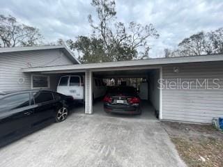 view of vehicle parking with a carport and driveway