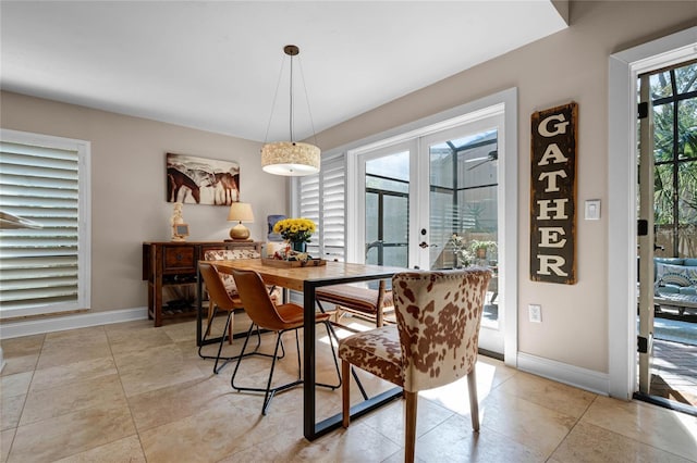 dining room featuring french doors, light tile patterned flooring, and baseboards