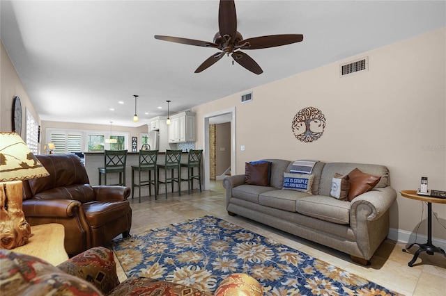 living area featuring visible vents, baseboards, and light tile patterned floors