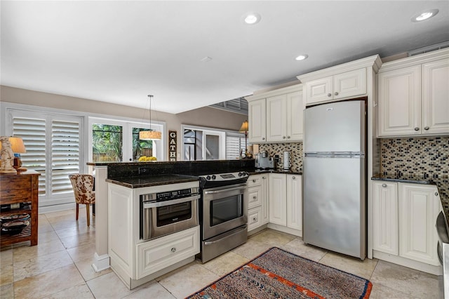 kitchen with recessed lighting, a peninsula, appliances with stainless steel finishes, backsplash, and pendant lighting