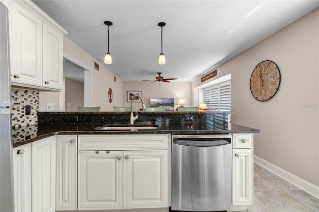 kitchen with decorative light fixtures, visible vents, stainless steel dishwasher, a sink, and dark stone counters