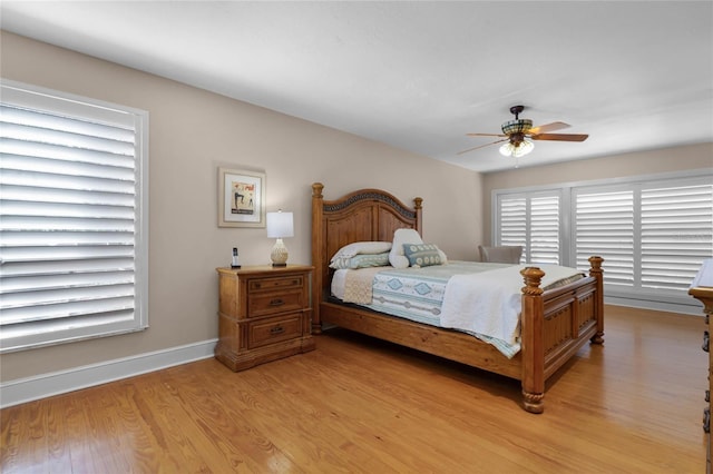 bedroom featuring a ceiling fan, baseboards, and light wood finished floors